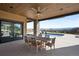 Outdoor patio area with dining table and chairs overlooking the pool and scenic landscape at 3148 Keep Dr, Sedalia, CO 80135