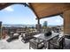 Covered patio with outdoor seating, dining table, and a stunning mountain view at 3148 Keep Dr, Sedalia, CO 80135
