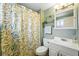 Bright bathroom featuring a shower with a curtain, neutral paint, and a functional sink at 2461 Niagara St, Denver, CO 80207
