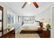 Comfortable bedroom featuring carpet, dual windows, a ceiling fan, and natural light at 2461 Niagara St, Denver, CO 80207