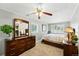 This cozy bedroom features carpeted floors, a ceiling fan, and dual windows for natural light at 2461 Niagara St, Denver, CO 80207