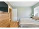 Bright bedroom with wood floors, natural light, and a view to a doorway, plus a dresser at 2461 Niagara St, Denver, CO 80207