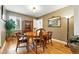Cozy dining room features hardwood floors, a wooden table and four chairs, and a decorative mirror at 2461 Niagara St, Denver, CO 80207