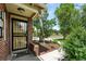 Close-up of the home's entrance, featuring a secure screen door and landscaped garden at 2461 Niagara St, Denver, CO 80207