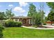 Inviting brick home with lush green lawn and established landscaping, a welcoming entrance at 2461 Niagara St, Denver, CO 80207