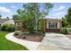 Beautifully landscaped front yard with mature birch tree and curved walkway leading to the house at 2461 Niagara St, Denver, CO 80207