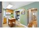 Practical kitchen with wooden cabinets, an island and adjoining laundry area and hallway at 2461 Niagara St, Denver, CO 80207