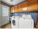 Functional laundry room features cabinetry, a washer and dryer, and easy access to the exterior at 2461 Niagara St, Denver, CO 80207