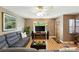 Open-concept living room featuring a large sectional, entertainment center, and stylish decor at 2461 Niagara St, Denver, CO 80207