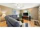 Cozy living room featuring a large sectional, flat-screen TV, and natural light at 2461 Niagara St, Denver, CO 80207