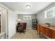 Comfortable office with neutral carpet, desk, chair, and wood sideboard for storage at 2461 Niagara St, Denver, CO 80207