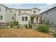 Exterior of home showcasing charming backyard with privacy fence and mature landscaping at 8926 Swan River St, Littleton, CO 80125