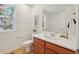 Bathroom boasts stained glass window, neutral countertops, and decorative fixtures at 8926 Swan River St, Littleton, CO 80125