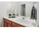 Bathroom features a vanity with a sink, decor, and a view of the walk-in shower at 8926 Swan River St, Littleton, CO 80125