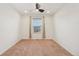 Bright bedroom with neutral carpet, white walls and a window, perfect for relaxation at 8926 Swan River St, Littleton, CO 80125