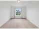 Bright bedroom with neutral carpet, white walls and a window, perfect for relaxation at 8926 Swan River St, Littleton, CO 80125