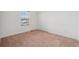 A simple bedroom with neutral carpet and a window, ideal for a peaceful retreat at 8926 Swan River St, Littleton, CO 80125