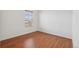 Empty bedroom with hardwood flooring, a window, and a closet, ready for personal touches at 8926 Swan River St, Littleton, CO 80125