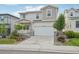 Inviting two-story home featuring a two-car garage, a covered porch, and a landscaped front yard at 8926 Swan River St, Littleton, CO 80125