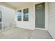 Covered front porch highlighting the entrance, a Ring doorbell, and a view of the neighborhood at 8926 Swan River St, Littleton, CO 80125