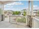 View from the front porch showcasing the neighborhood, beautiful stonework, and a cozy outdoor space at 8926 Swan River St, Littleton, CO 80125
