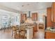 Open concept kitchen features an island with seating that connects to the dining and living areas at 8926 Swan River St, Littleton, CO 80125