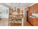Modern kitchen features an island with seating, stainless steel appliances, and wood floors at 8926 Swan River St, Littleton, CO 80125
