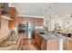 Modern kitchen features stainless steel appliances, granite countertops, and an island with seating at 8926 Swan River St, Littleton, CO 80125