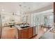 Open concept kitchen with island seating flows into the living and dining areas at 8926 Swan River St, Littleton, CO 80125