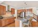 Beautiful kitchen features an island with a sink, stainless steel appliances, and wood floors at 8926 Swan River St, Littleton, CO 80125