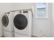 Laundry room with white washer and dryer and a window at 8926 Swan River St, Littleton, CO 80125