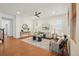 Bright living room features wood floors, ceiling fan, and lots of natural light at 8926 Swan River St, Littleton, CO 80125