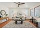 Open living room featuring hardwood floors, stylish furnishings, and a modern ceiling fan at 8926 Swan River St, Littleton, CO 80125