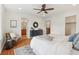Bright main bedroom with hardwood floors, ceiling fan, and ensuite bathroom at 8926 Swan River St, Littleton, CO 80125