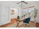 Bright office with a wooden desk, comfortable blue chair, and lots of natural light from the window at 8926 Swan River St, Littleton, CO 80125
