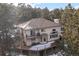 Aerial view of the home showcasing decks, bay window and tile roof at 2492 Baldy Ln, Evergreen, CO 80439