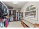 Walk-in closet with custom shelving, ample storage space, and a window seat at 2492 Baldy Ln, Evergreen, CO 80439