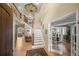 Spacious foyer with staircase, beautiful light fixture and hardwood flooring at 2492 Baldy Ln, Evergreen, CO 80439