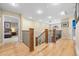 Second floor hallway with hardwood floors and neutral walls leading to bedrooms at 2492 Baldy Ln, Evergreen, CO 80439