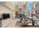 Comfortable living room with stone fireplace and wall of windows providing plenty of natural light at 2492 Baldy Ln, Evergreen, CO 80439