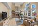 Comfortable living room with stone fireplace and wall of windows providing plenty of natural light at 2492 Baldy Ln, Evergreen, CO 80439