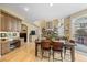 Open floor plan with a dining area, desk, and a cozy living room with a stone fireplace at 2492 Baldy Ln, Evergreen, CO 80439