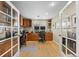 Bright home office featuring custom wood cabinets, built-in desks, and a large window for natural light at 2492 Baldy Ln, Evergreen, CO 80439