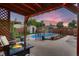 Inviting backyard featuring a swimming pool, fire pit, pergola, and beautifully landscaped yard at 4329 S Clarkson St, Englewood, CO 80113