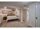 Large bedroom featuring neutral carpet, a large bed frame with side tables, and many access doors at 4329 S Clarkson St, Englewood, CO 80113
