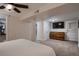 Spacious bedroom with neutral carpet, dresser and TV on wall, a double closet, and white doors at 4329 S Clarkson St, Englewood, CO 80113