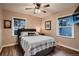 Bedroom features wood floors, a ceiling fan, and natural light from two windows at 4329 S Clarkson St, Englewood, CO 80113