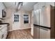 Updated kitchen features stainless steel appliances, white cabinets, granite countertops, and backyard access at 4329 S Clarkson St, Englewood, CO 80113