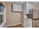 Bright kitchen with stainless steel refrigerator, white cabinets, granite countertops and backyard access at 4329 S Clarkson St, Englewood, CO 80113