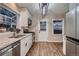 Updated kitchen with stainless steel appliances, white cabinets, granite countertops, and a door to the backyard at 4329 S Clarkson St, Englewood, CO 80113